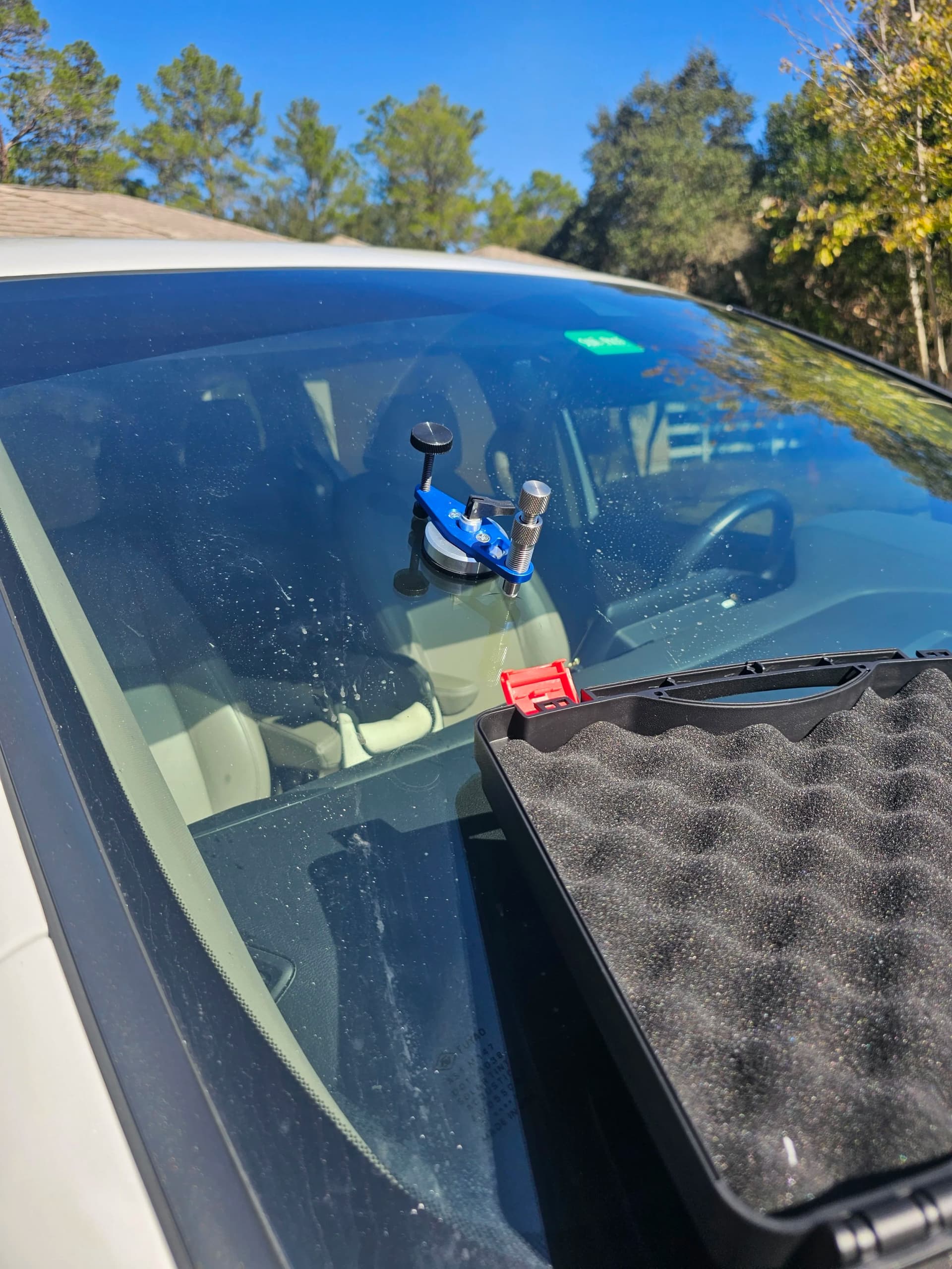 Windshield chip repair in progress, UV-cured polymer resin being applied to rock chip damage