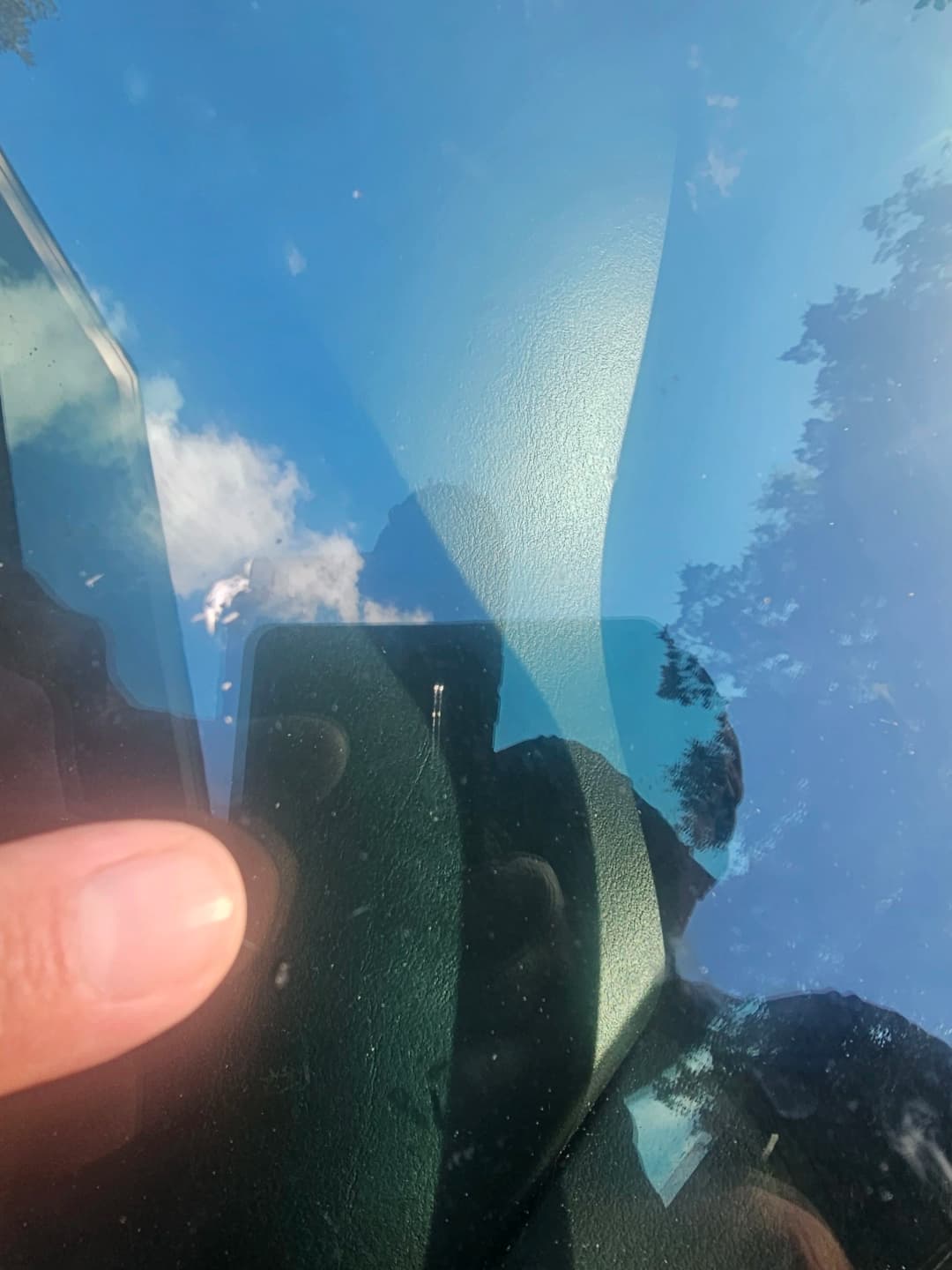 Windshield chip after professional repair, nearly invisible